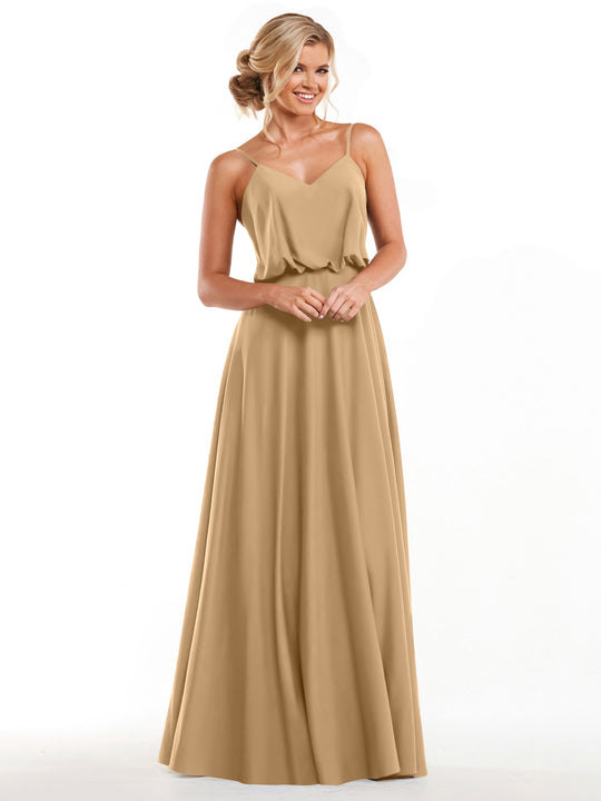 A smiling woman in Avery Austin 83040—a sleeveless, floor-length A-line dress with a flowy skirt and thin straps—stands against a plain white background, her blonde hair in an elegant updo.