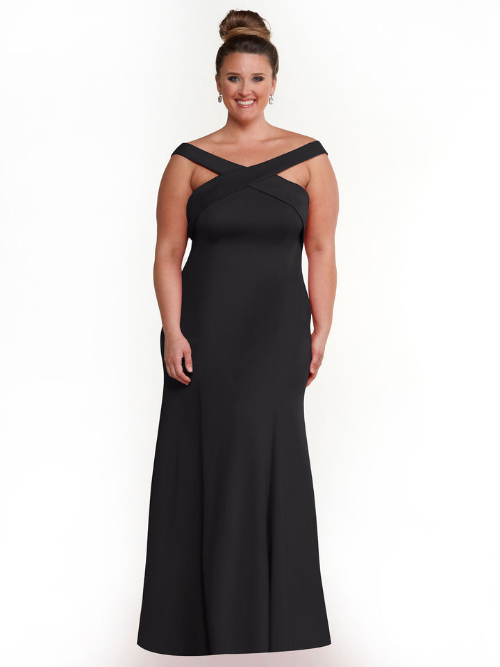 A woman with brown hair in a bun smiles against a white background, wearing Avery Austin&