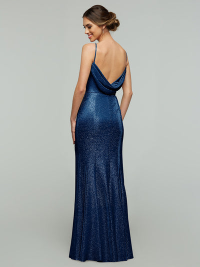 Wearing the Avery Austin 84001 Tried On Sample, a woman models a glitter knit, floor-length dark blue fitted dress with thin straps and a draped, low-cut back—an elegant updo completes this perfect sample dress look.