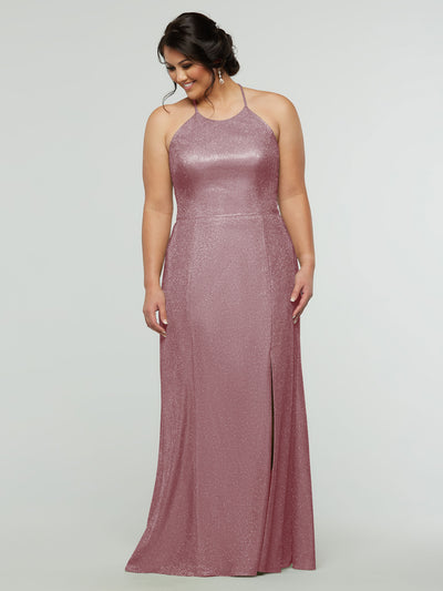 A woman wearing the averyaustin 84005 - Tried On Sample in Glitter Mauve—a sleeveless, glitter knit sheath dress with a high neckline and front slit—stands against a light gray background, looking down and smiling.