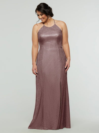 A woman models the averyaustin 84005 Tried On Sample, a sleeveless, floor-length glitter knit sheath dress in Glitter Rose Gold with a halter neckline and front slit, standing against a plain light background and smiling.