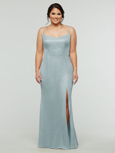 A woman smiles against a plain light gray background wearing the averyaustin 84008 - Tried On Sample in Glitter Sky Blue, a shimmery sheath dress with spaghetti straps and a thigh-high slit.