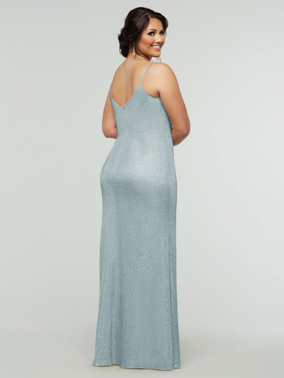 A woman faces backward, smiling in the AveryAustin 84008 Tried On Sample—a sparkly light blue sheath dress with spaghetti straps. Her hair is up, and she wears dangling earrings, set against a plain light gray background.